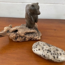 Carved bear sculpture and polished Petoskey stone.