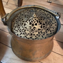 Antique copper pot with brass filigree lid