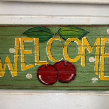 Painted wood welcome sign