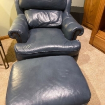 Pair of matching “Classic Leather” chairs with matching ottomans