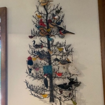 Wrought iron metal tree with various bird ornaments