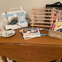 Old farm table, White sewing machine, crafting supplies
